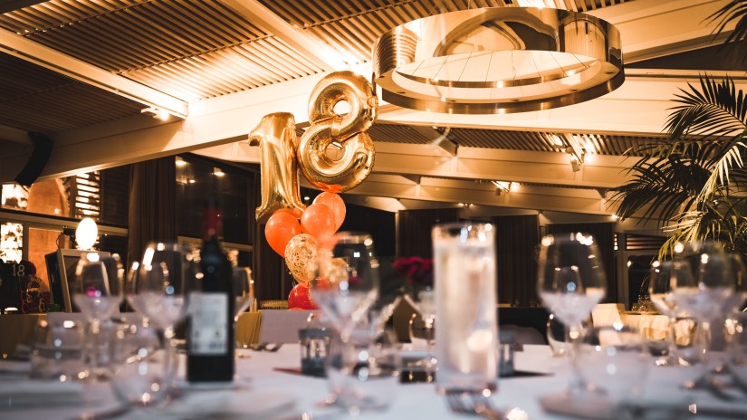 An event hall with a table set up for dinner