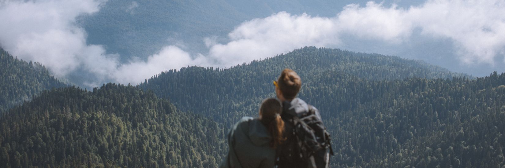 A couple enjoying the breath taking view of the mountains