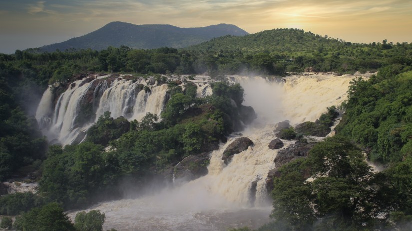 view of a waterfall during sunset