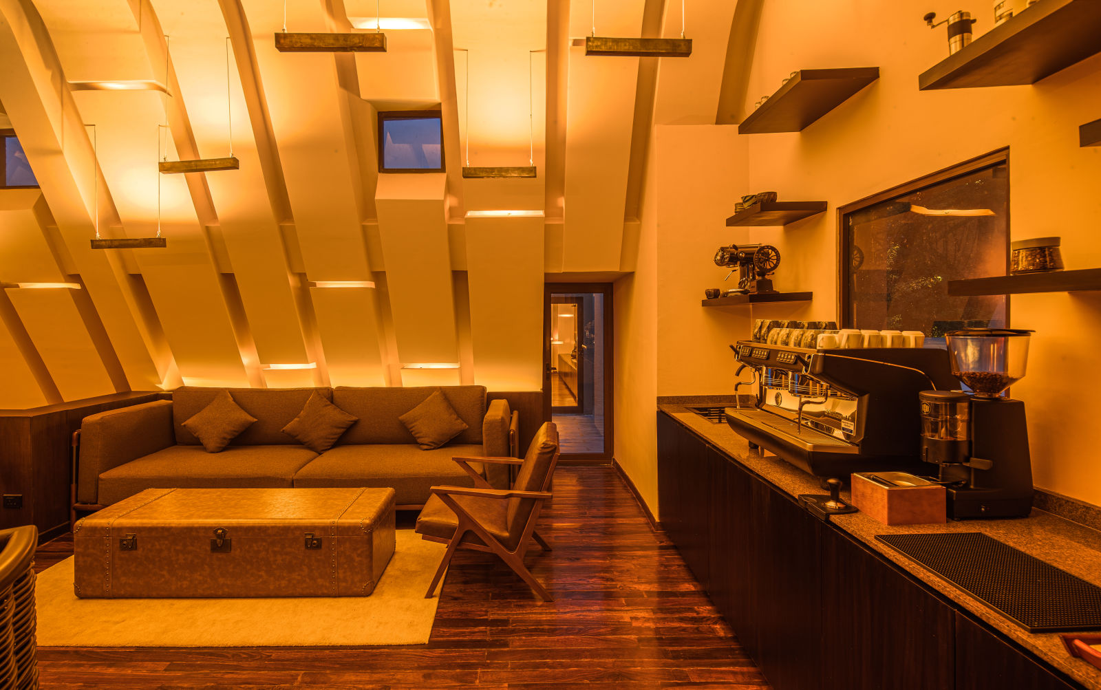 Modern coffee lounge with comfortable seating and  a coffee machine.