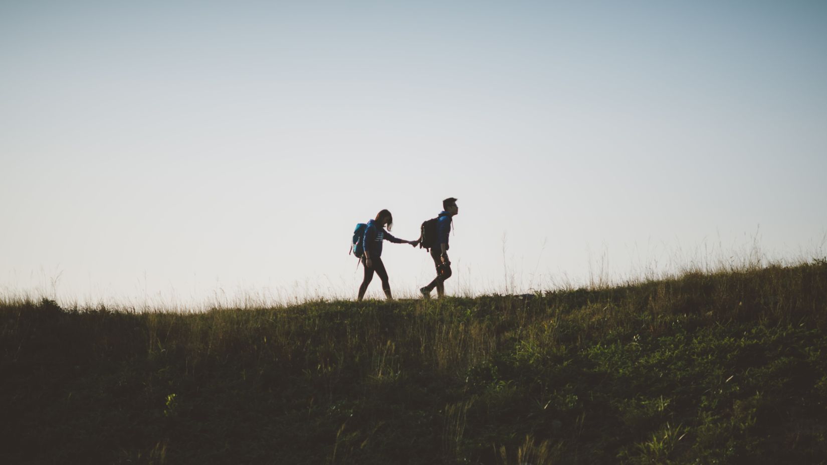 Pair trekking during twilight hours