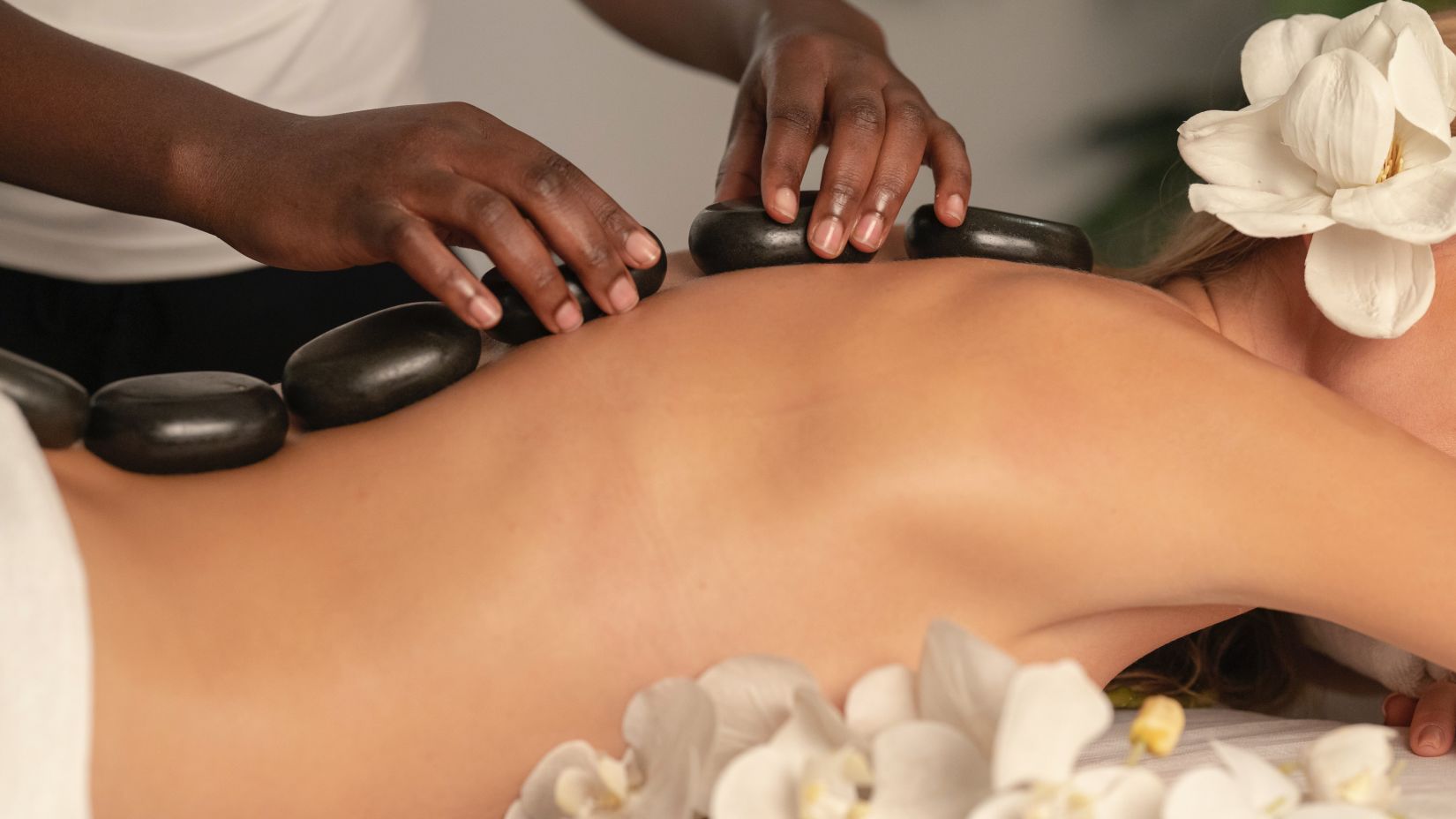 a woman getting a hot stone massage