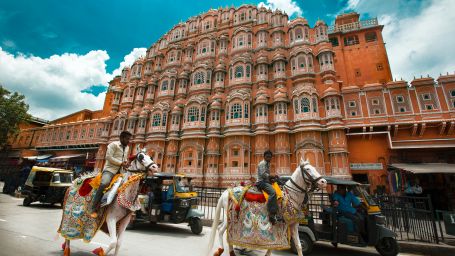 two horse riders riding a horse in Hawa Mahal road in Udaipur