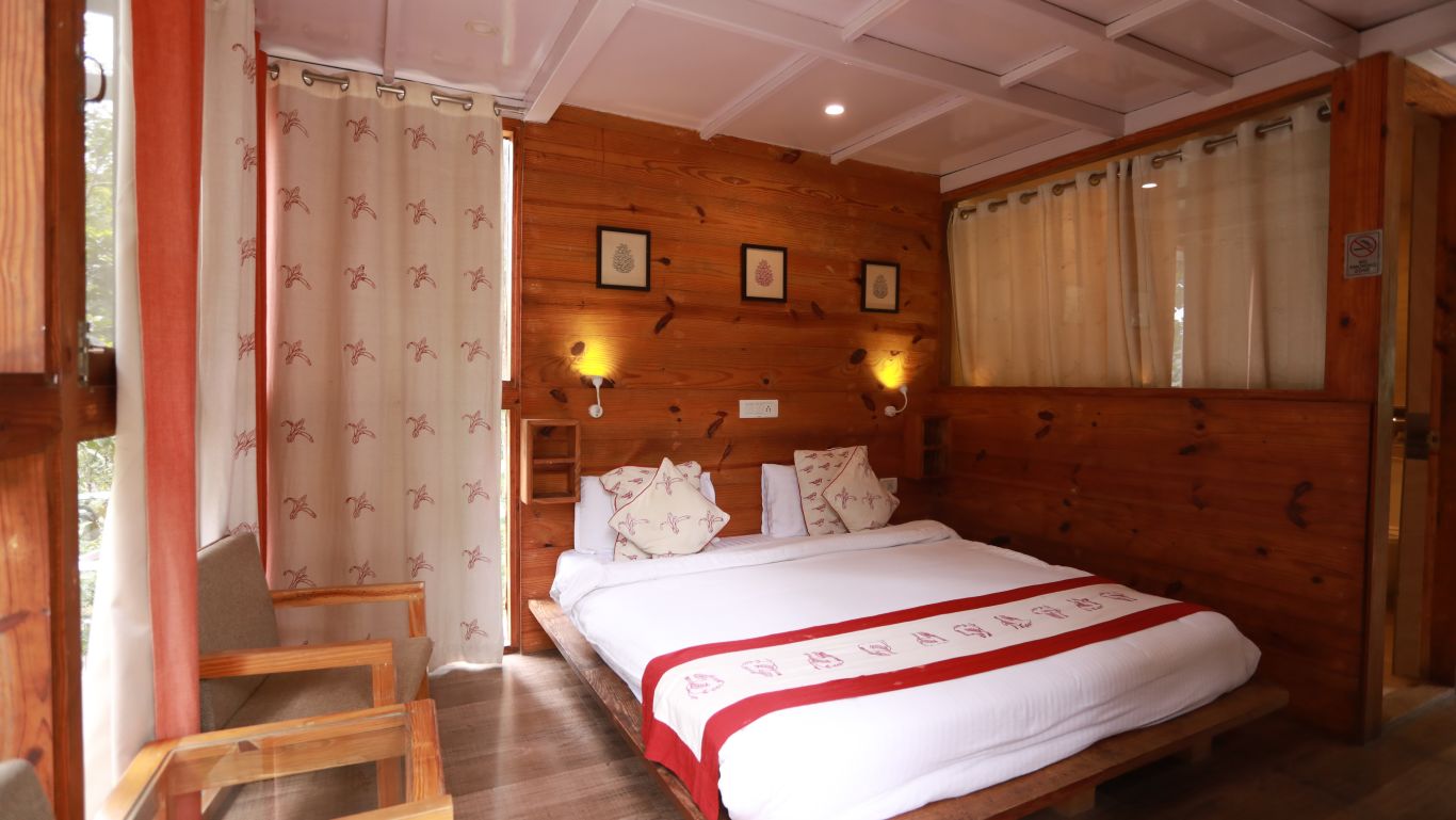 double bed and chair at The Sal Woods Forest Resort & Spa