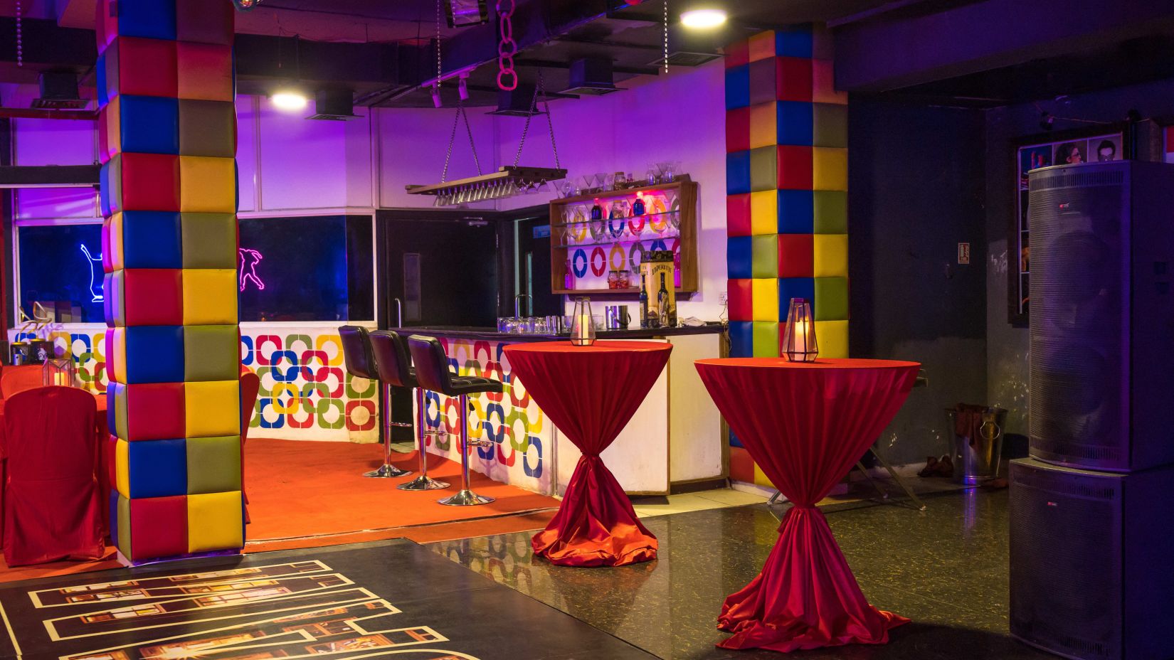 A bar counter with bar stools inside discotheque - Narayani Heights