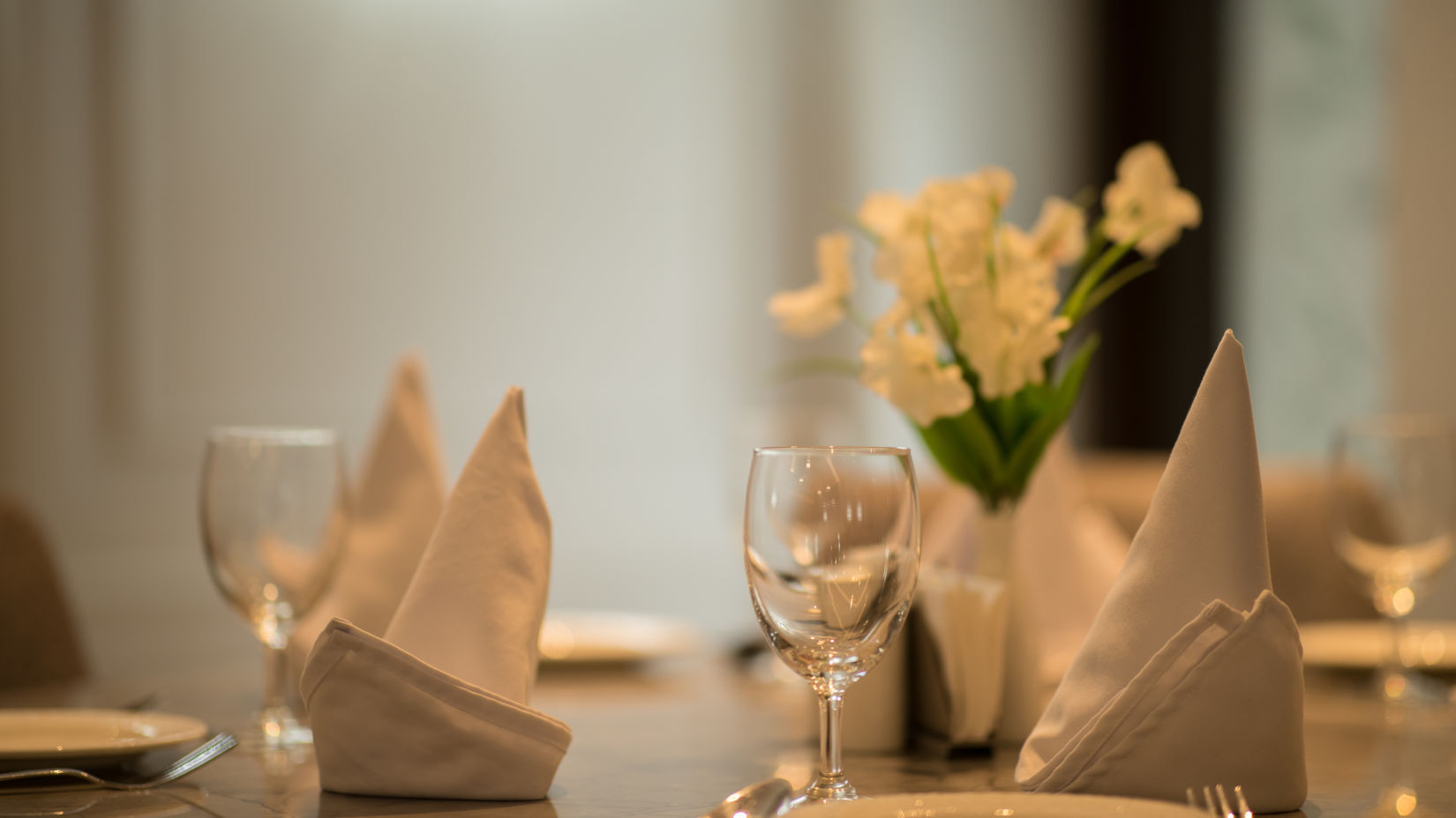 The table at La Zafferano decked with plates and cutlery at Ramada by Wyndham Kapurthala