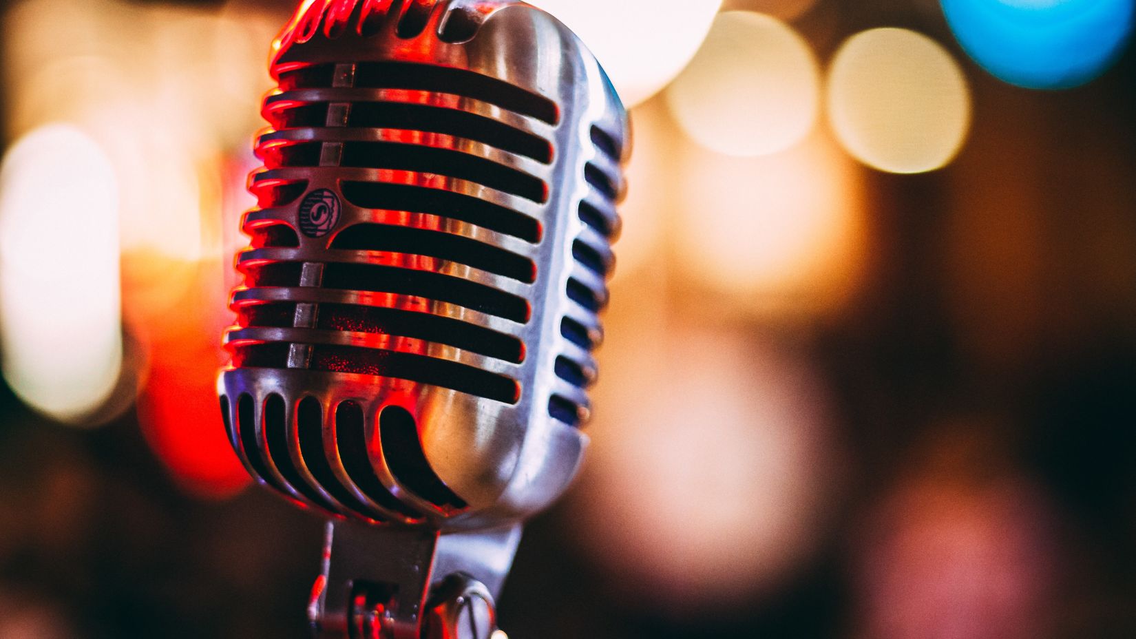 Close-up shot of a carbon microphone in a colourful background