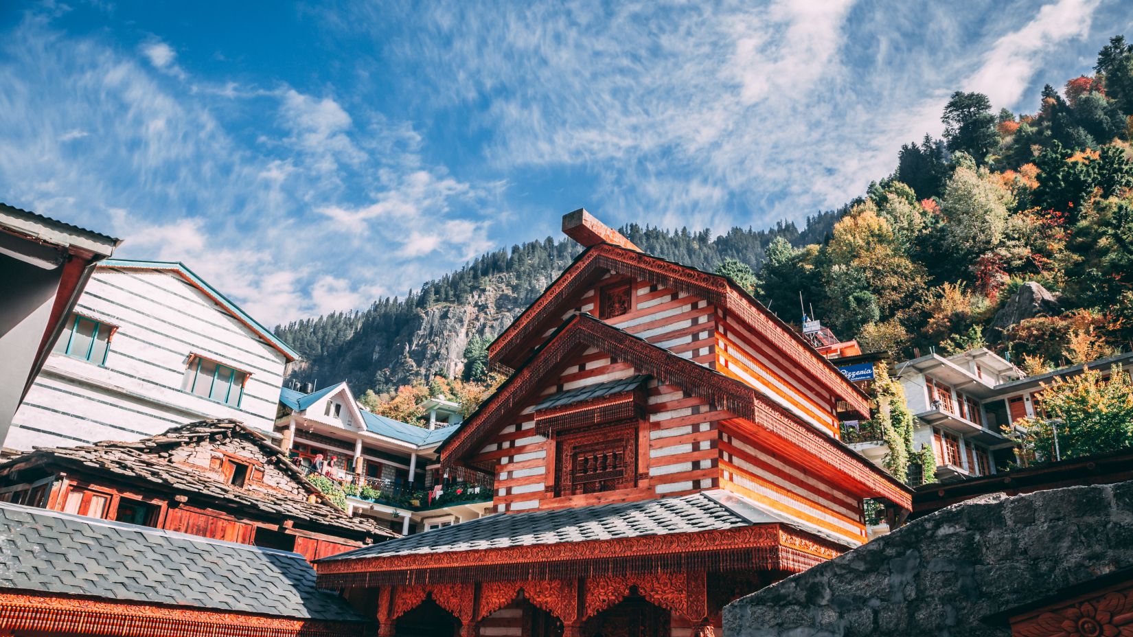 Traditional red house in mountain setting.