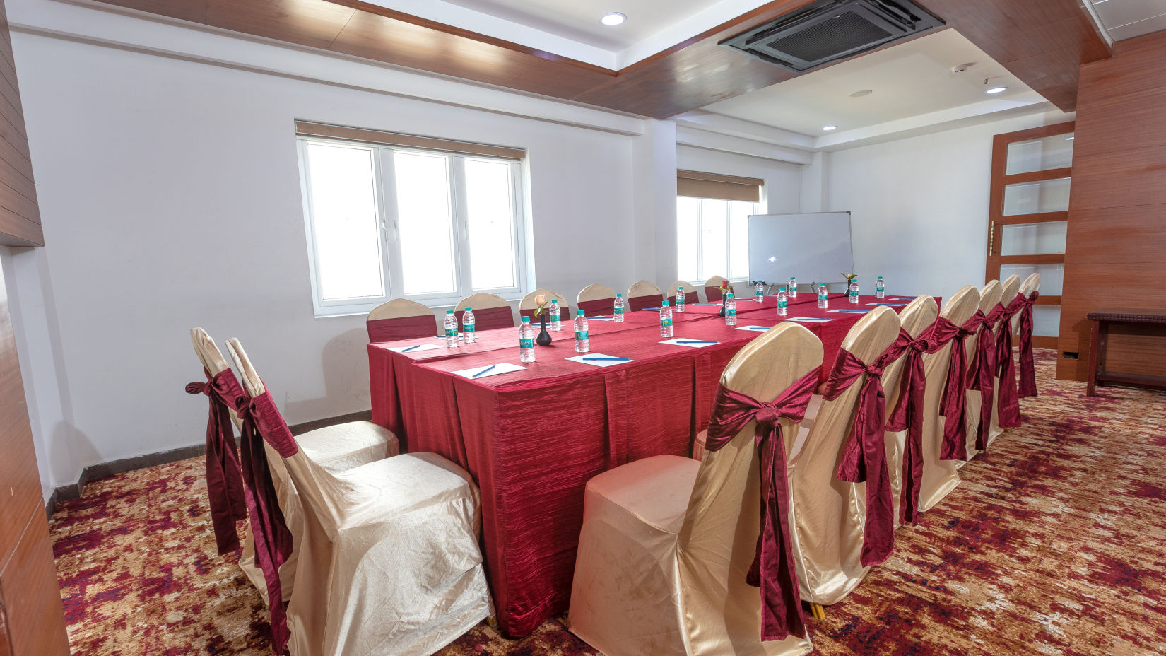  suprabath hall with a long table and multiple chairs -The Saiaba Hotel