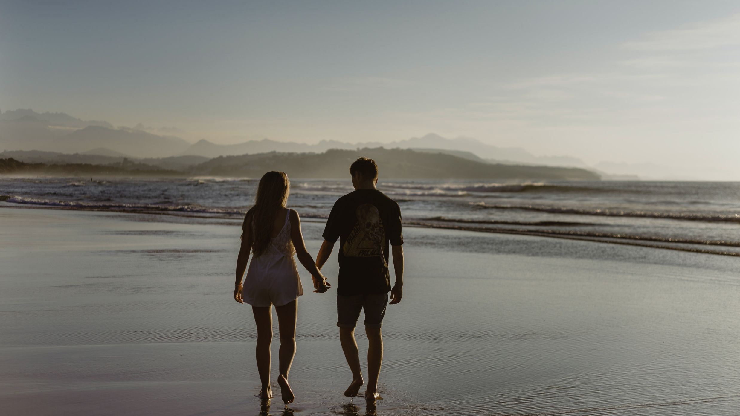 a couple walking on the beach