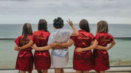 group of girls standing, facing seafront