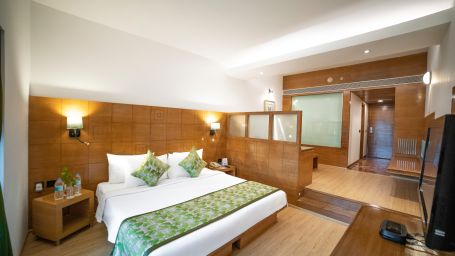 Premier Rooms at The Orchid Hotel with beds and lights on - The Orchid Hotel Pune