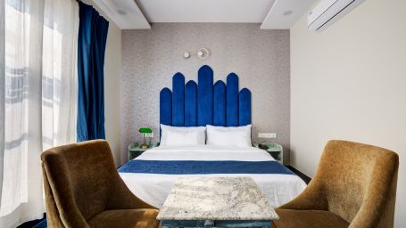 Superior Deluxe Room with blue themed interior and blue & white curtains - The White Moon