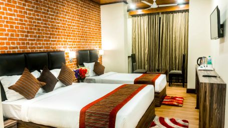 Premium room at Tin Tin Boutique Hotel with a double bed and a single bed