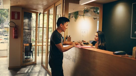 a man standing by a reception counter