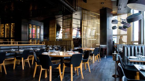 Seating arrangements inside a restaurant with the sun light shining through the windows