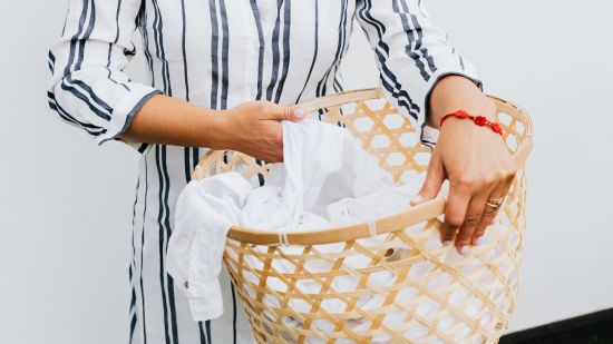 person holding a basket of laundry