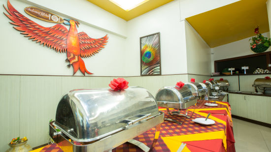 Buffet service on a table with a painting in hung on the wall at Andaman Kitchen - Hotel Shompen