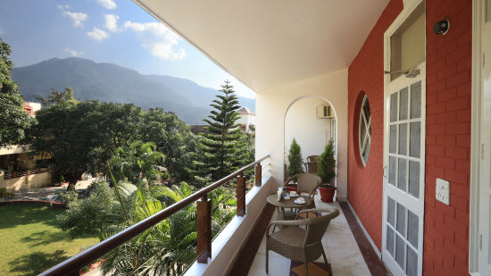 Super Deluxe Room balcony offers a view of the surrounding greenery - Lamrin Boutique Cottages Rishikesh