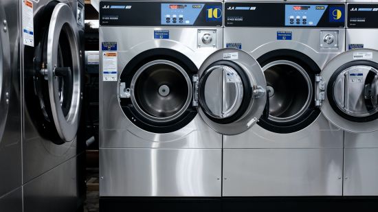 many front load washing machines stacked side by side