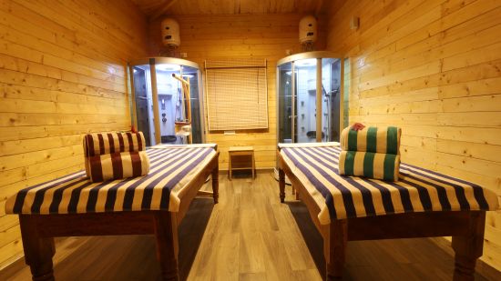 A massage room with two beds at Lotus Eco Beach Resort Konark.