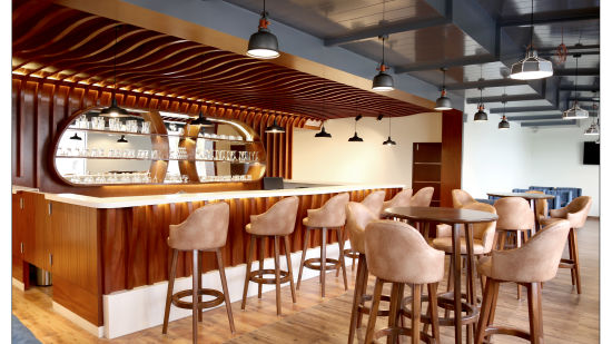 wide angle view of lotus bar with a bar counter and brown shade of furniture - Royal Lotus View Resotel3