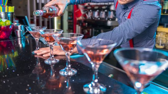 bartender pouring drinks in a glass