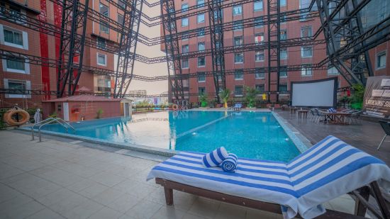 an image of a pool and sunbed  - The Orchid Hotel Pune