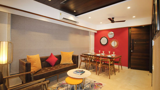 living room with wooden furnishings and cosy sofas at theory9 khar