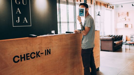 A person waits to check-in at the hotel reception