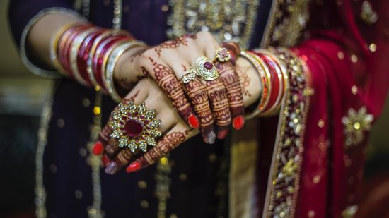 a close up shot of the jewellery that a bride is wearing on her wedding