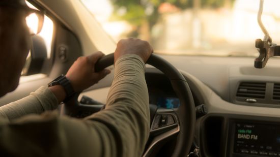 A  man driving a car.