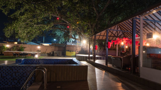 The pool and poolside area pictured at night