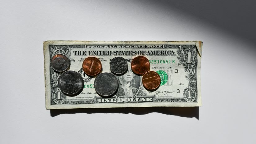 An aerial view of money kept on a table with a dollar