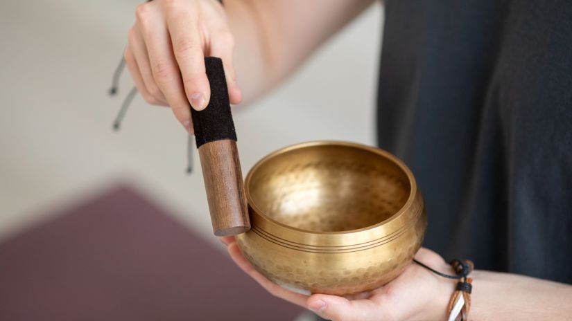 an image of a hand practicing sound yoga or sound therapy 