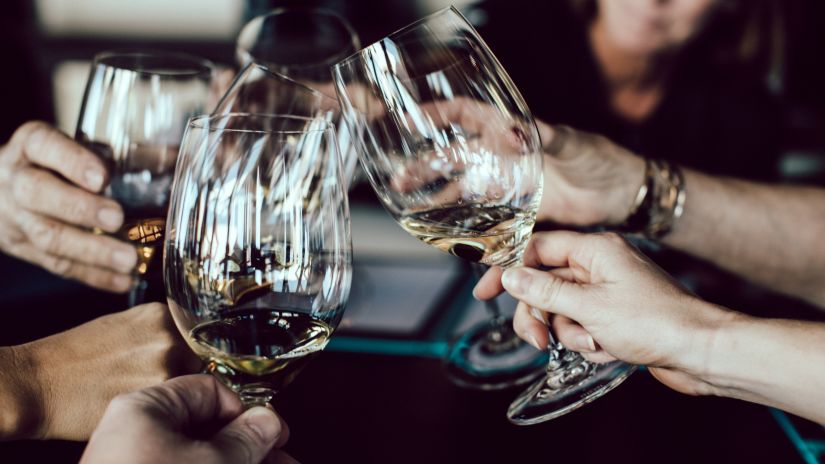 A group of people clinking their wine glass