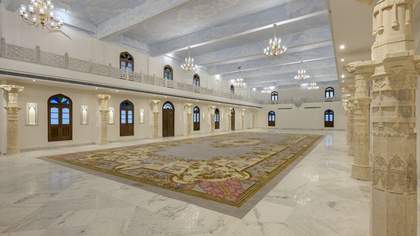 Fateh Vilas Udaipur - Interior view of the Surya Prakash hall with white decor and chandeliers