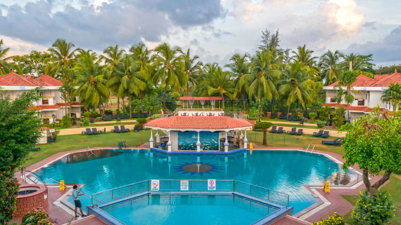 aerial view of the swimming pool at heritage village resort and spa in goa