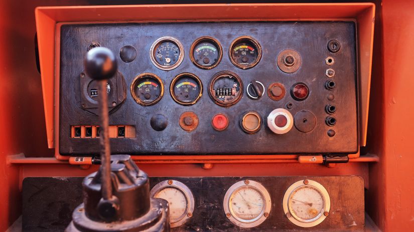 The dashboard control panel of a vintage Soviet heavy equipment