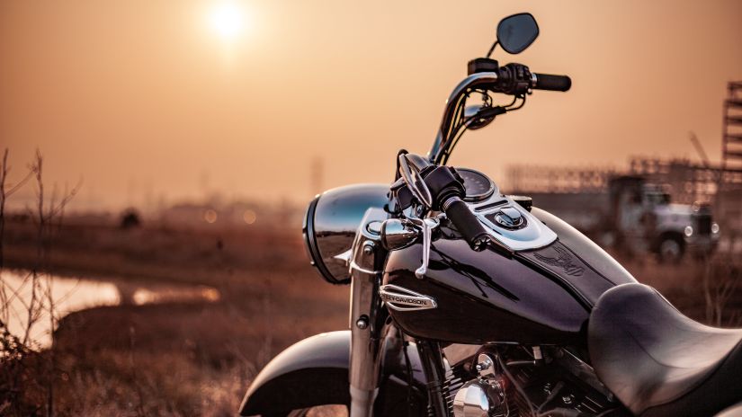 a sunset shot of a parked bike on the side of the road