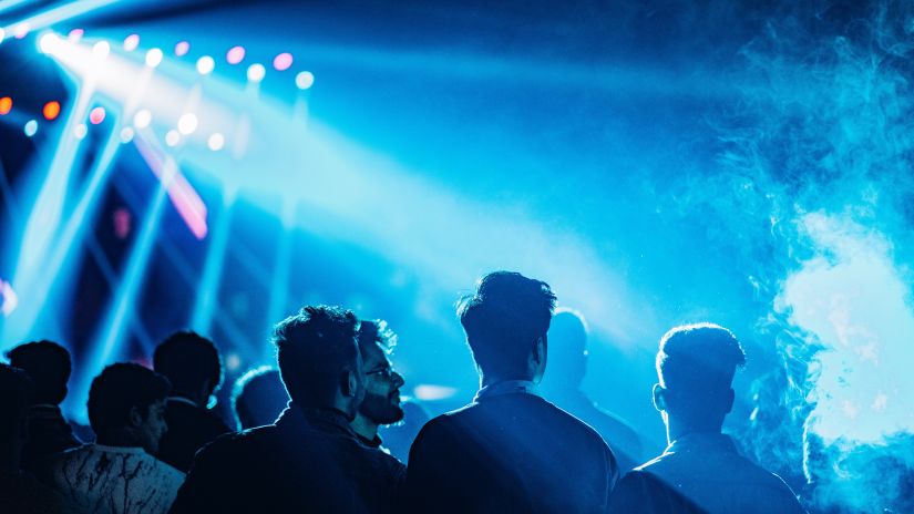 silhouette of people in blue disco light