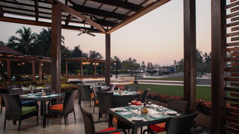 The outside seating area at Palms, the multi-cuisine restaurant - Kenilworth Resort & Spa, Goa