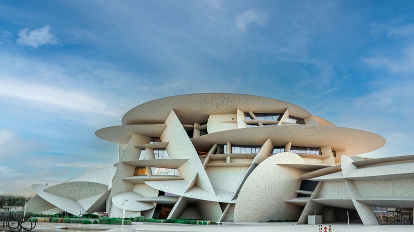 Facade image of Museum of Islamic Art in Qatar with blue sky in the background