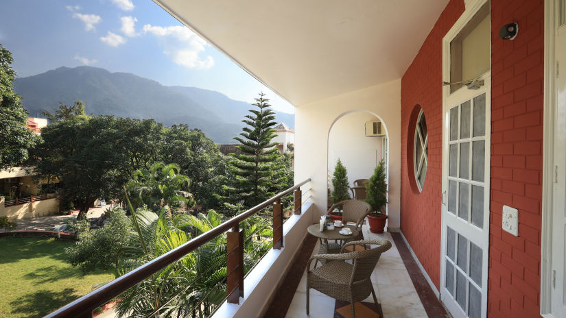 Super Deluxe Room balcony offers a view of the surrounding greenery - Lamrin Boutique Cottages Rishikesh