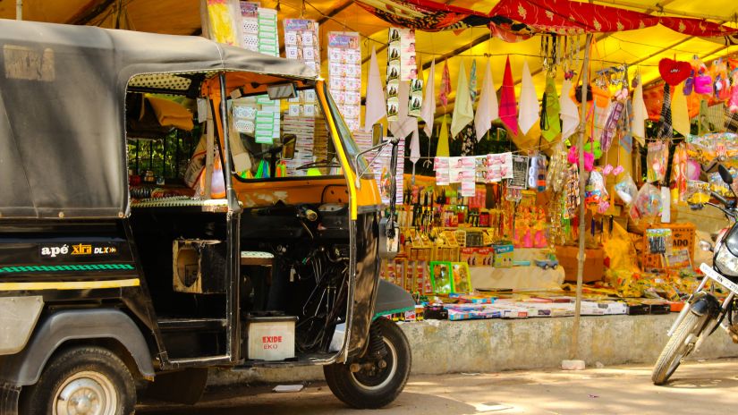 A local Indian market with beautiful shades of yellow in the background and an auto-rickshaw parked in front @ Lamrin Norwood Green, Palampur