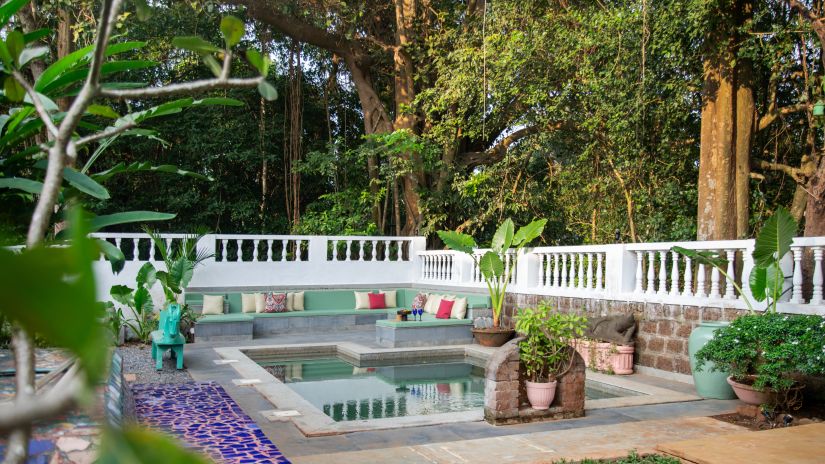 white fenced oool surrounded by greenery @ Lamrin Ucassaim Hotel, Goa