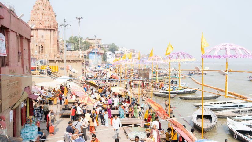 a wide angle shot of the ghats of Prayagraj filled with visitors and locals