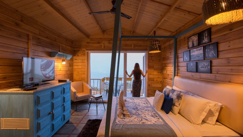 a woman standing at the attached balcony of a room