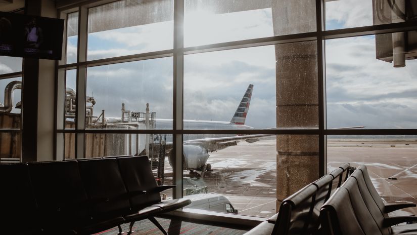 view from the gate with many seats of an airport