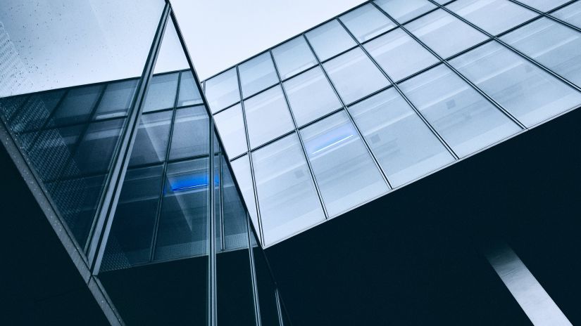 facade of an IT building with glass windows and the sky in the background